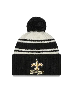 New Orleans Saints New Era 2022 Sideline - Sport Cuffed Pom Knit Hat - Cream/Black
